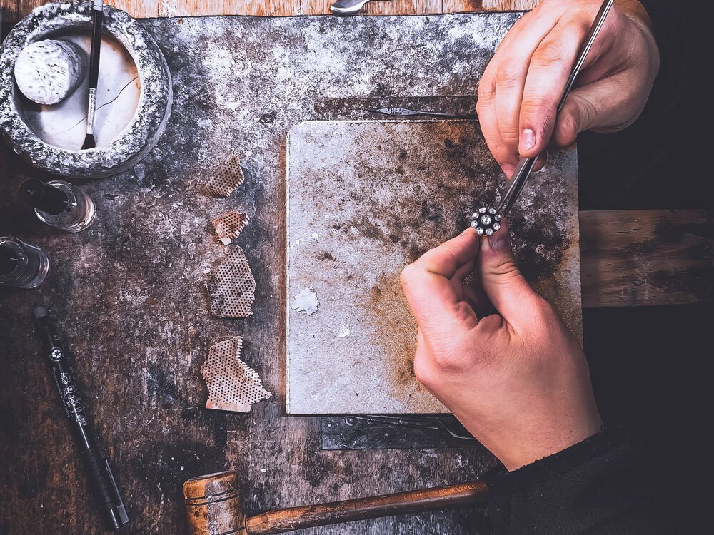 Small diamonds being set into a piece by hand