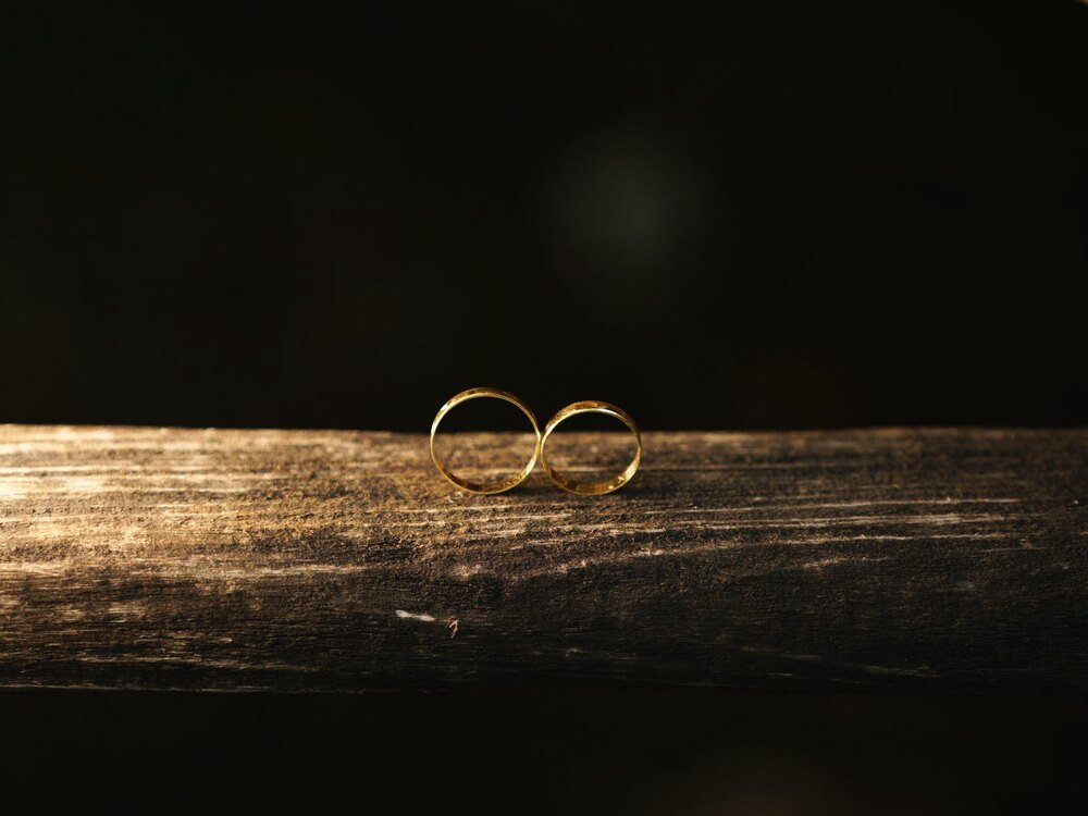 Two gold wedding bands catching warm light