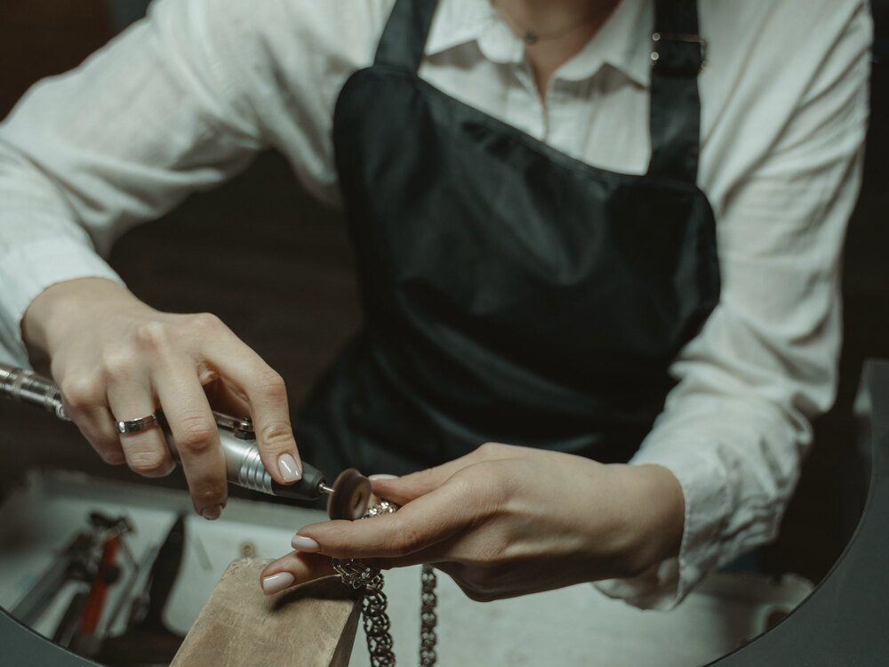 A jeweller working on a ring at the bench